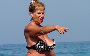 older couple essentially beach posing in the buff